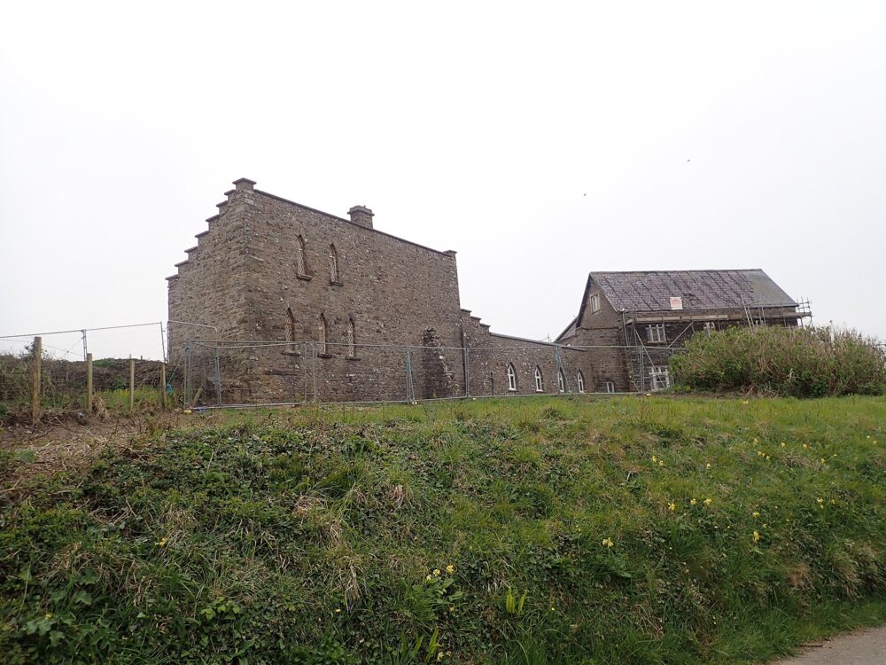 Old stone hotel building above the coast