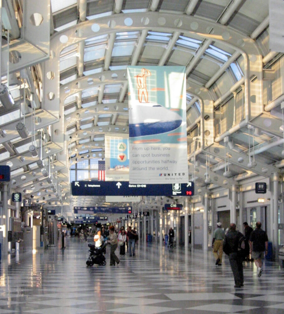 Airport boarding concourse with gate signs